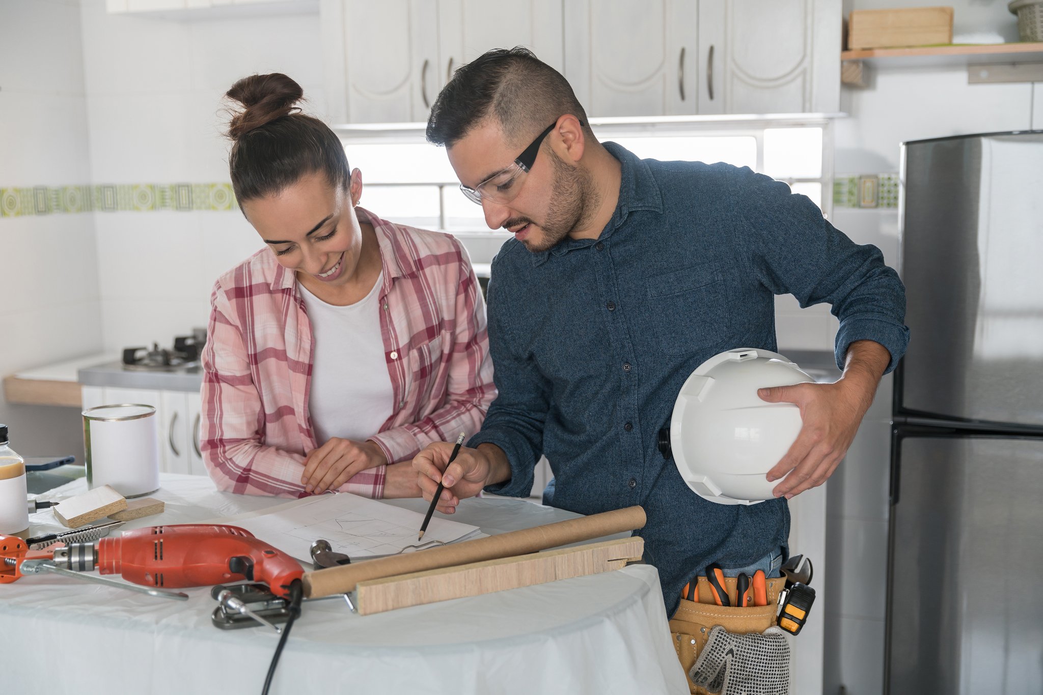Contractor showing client blueprint